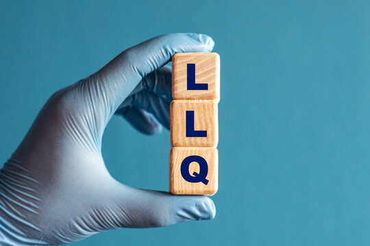 LLQ is an acronym on cubes held by a hand in a blue glove