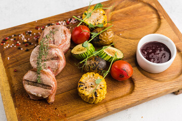 restaurant dish with grilled meat and vegetable side dish