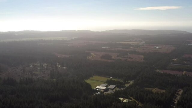 Drone Flying Towards Cranberry Bogs In Port Orford, Oregon At Daytime - aerial wide shot
