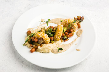 fish cakes with vegetable garnish and mashed potatoes