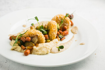 fish cakes with vegetable garnish and mashed potatoes