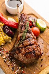 restaurant dish with grilled meat and vegetable side dish