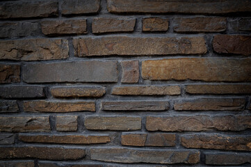 Antique brick wall, dark brown. Grunge stone texture.
