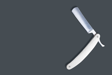 Straight metal razor with a wooden handle.