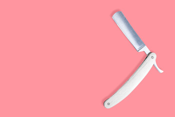 Straight metal razor with a wooden handle.