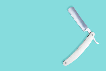 Straight metal razor with a wooden handle.