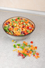 Assorted frozen vegetables in a plate. Semi-finished vegetable mix for instant cooking. Food concept.