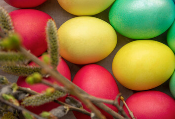 Fototapeta na wymiar Easter eggs and blossoming branches on a light background. close-up