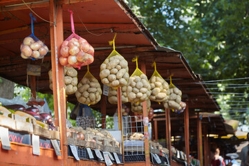 Potato sacks hanging on market stall in Bulgaria. Potatoes contain many good nutrients. Potatoes...