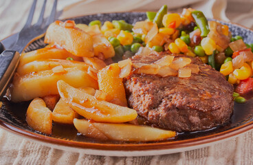 Beefburger with chips, vegetables and gravy.