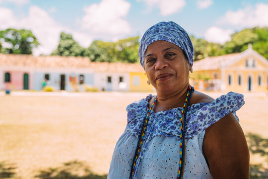 Happy Brazilian woman dressed in the traditional Bahian costume of the Umbanda religion, in the historic center of Porto Seguro