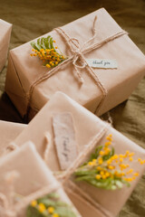 eco-friendly gift wrapping in Kraft paper with yellow flowers and words thank you. High quality photo