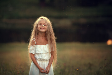 A butterfly is sitting on a nose of beautiful long-haired girl. Image with selective focus and toning