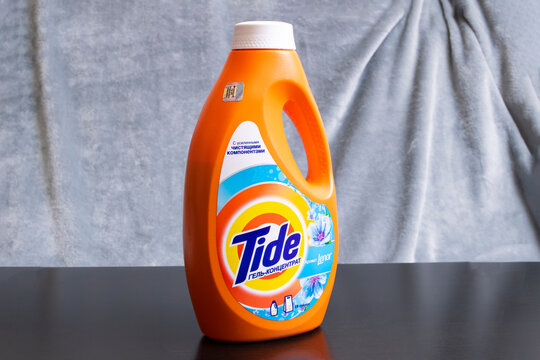 BELARUS, MINSK - 22 MARCH, 2021: Tide liquid detergent on a wooden table