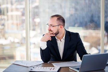 The corporate madman is sitting at the computer in the office and going crazy, the emotional portrait of the man at the table. Crazy worker at his workplace