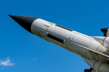 Old missile or rocket pointing at the blue sky