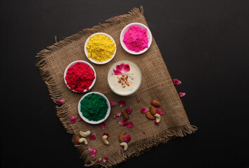 Indian festival Holi concept - Traditional Indian beverage Thandai Sardai milk festival food, with nuts and color in bowl.