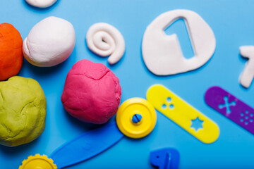 Homemade plasticine, plasticine, play dough on a colored background. Molding clay
