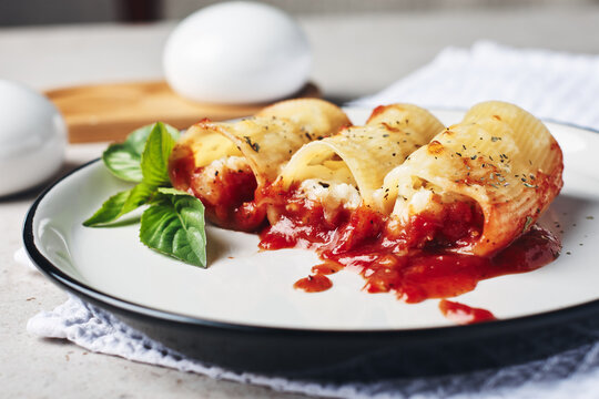 Pasta stuffed with cheese and fish in tomato sauce.