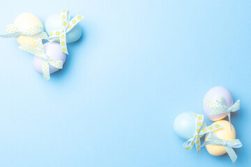 Easter banner. Colourful egg with tape ribbon on pastel blue background in Happy Easter decoration. Foil minimalist egg design, modern top view template.