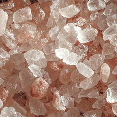 Pink himalayan salt rocks close up. Macro. Pink background. Sunlight