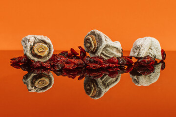 dried fruits persimmons and dates on an orange background 