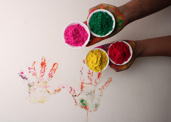 holi greetings view of hands with gulal for Hindu spring festival of colours