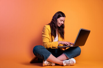 freelancer at a laptop, a young specialist working remotely. A young woman in modern-style clothing