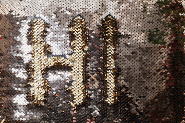 Fragment of a small pillow in a pillowcase with metal petals