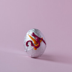 Easter egg on a pastel pink background painted in tempera colors. Minimal concept of Easter holidays