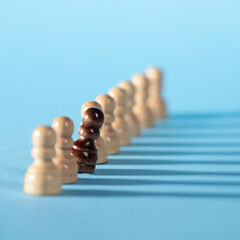 chess pieces in a row, white pawns on a blue background,