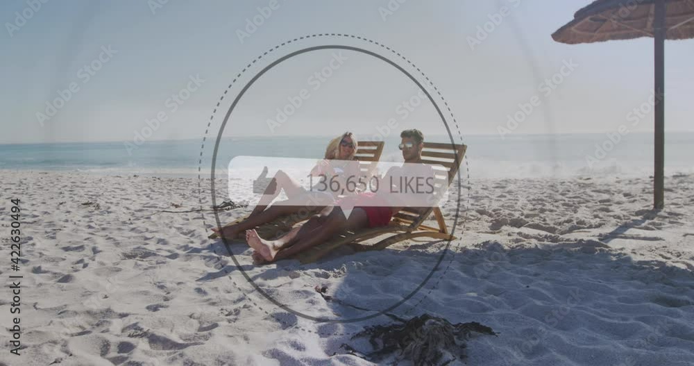 Poster animation of speech bubble with likes text and numbers over couple in deckchairs on beach