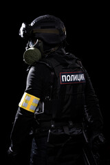 Male in black uniform conforms to Police SWAT. Patch on the back with the inscription Police in Russian. Black background (red and blue lights)
