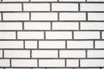 Clinker brick of white color. Clinker facade of the house. Tiles for outdoor decoration.