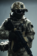 Male special forces soldier in grey winter uniform. Shot in studio on green background.