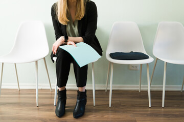 Beautiful woman holding a folder with her resume