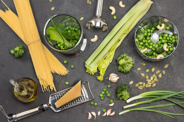 Set of vegetables on table and in blender bowl.
