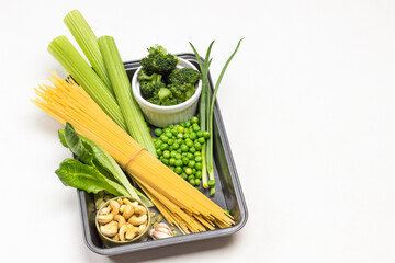 Pasta, vegetables and cashew nuts in pallet.