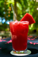 Glass cup of freshly squeezed watermelon juice with ice