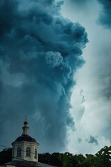 terrible clouds over the city. a sudden change in the weather. a heavy storm and thunderstorm is...