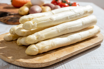 New harvest of high quality Dutch white asparagus washed, uncooked, tasty vegetarian dinner