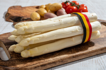 New harvest of high quality Belgian white asparagus washed, uncooked, tasty vegetarian dinner