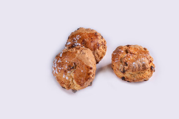 Freshly baked fruit scones, isolated on white.