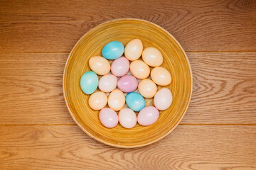 Colorful Easter eggs in pastel colors on a wooden background. Colored eggs for Easter. celebrate Easter 