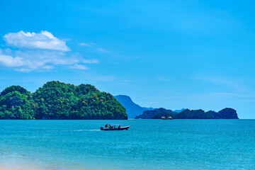 View from the beach to the rocks in the ocean away from the coast. Natural landscape of a tropical...