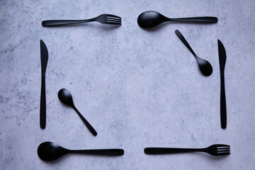 black cutlery on a marble table - 422636217