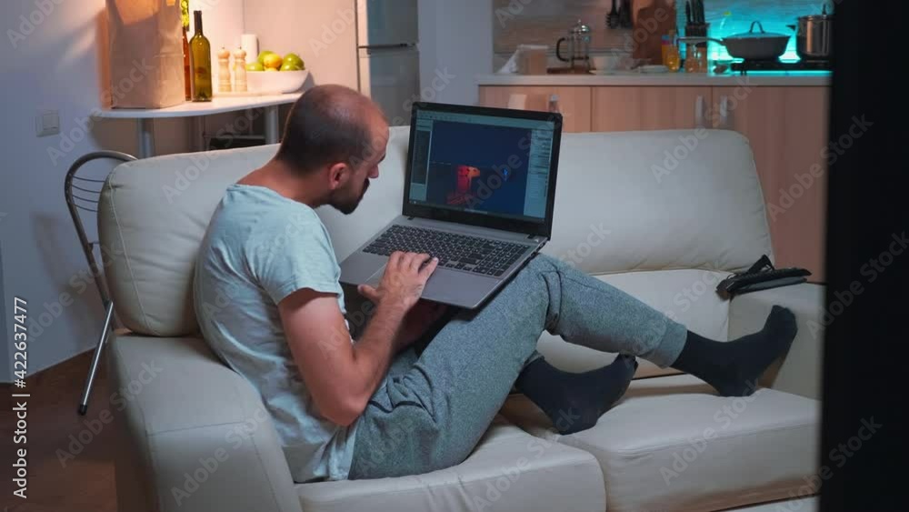 Poster professional game developer working on gameplay and game level late at night from the confort of his