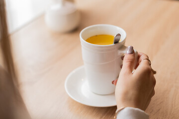 hand with a white cup