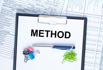 Text Method on the folder that is located on the financial reports with calculator and stationery...