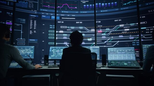 Professional IT Technical Support Specialists and Software Programmer Working on Computers in Monitoring Control Room with Digital Screens with Server Data, Blockchain Network and Surveillance Maps.  - Powered by Adobe